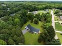 An aerial view of a home and neighborhood surrounded by mature trees and landscaping at 1115 Sides Rd, Salisbury, NC 28146