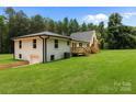 Inviting two-story home boasts a lush lawn and a charming wooden deck, blending comfort with outdoor beauty at 1115 Sides Rd, Salisbury, NC 28146