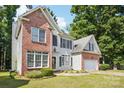 Two-story home boasts brick accents, light siding, a two-car garage, and a well-maintained lawn at 116 Scottie Ct, Rock Hill, SC 29730