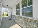 Close-up of the stone front porch with a great view of the house siding at 1207 Laggan Ln, Indian Trail, NC 28079