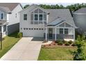 Beautiful exterior view of two-story home featuring an attached garage and manicured lawn at 1207 Laggan Ln, Indian Trail, NC 28079