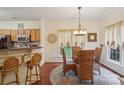 Cozy dining area with stylish lighting, seating for four, and access to the kitchen at 12342 Swan Wings Pl, Huntersville, NC 28078