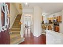 Inviting entryway with hardwood floors, staircase, and a view into the living spaces at 12342 Swan Wings Pl, Huntersville, NC 28078