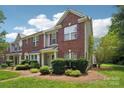 Well-maintained townhome with brick and siding, complemented by lush green lawn at 12342 Swan Wings Pl, Huntersville, NC 28078