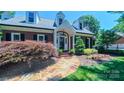 Charming brick home with stone path leading to the arched front door at 1240 Fawn Ridge Nw Rd, Concord, NC 28027