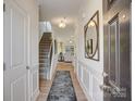 Inviting entryway featuring hardwood floors, staircase, and a decorative mirror at 1254 Langston Ln, Salisbury, NC 28144