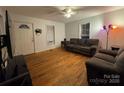 Inviting living area with hardwood floors, gray sofas, and ample sunlight at 128 Pine St, Shelby, NC 28152