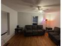 Cozy living room features hardwood floors, ceiling fan, and large window at 128 Pine St, Shelby, NC 28152