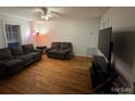 Open living room with hardwood floors, neutral walls, and natural light at 128 Pine St, Shelby, NC 28152