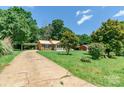 Quaint brick home with a metal roof, carport, and a spacious front yard at 142 Single Oak Dr, Troutman, NC 28166