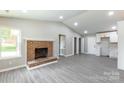 Open living room with fireplace, bright paint, with modern flooring at 142 Single Oak Dr, Troutman, NC 28166