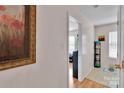 Hallway with light-colored walls, an adjacent room visible, and an art piece to the left at 15248 Pangborn Pl, Charlotte, NC 28278