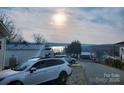 Scenic view showcasing a mobile home neighborhood with lake views and mature trees at 166 Eagle Dr, New London, NC 28127