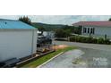 Picturesque street view showing well-maintained homes and a scenic mountain vista in the background at 166 Eagle Dr, New London, NC 28127