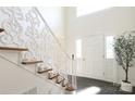 Elegant foyer featuring staircase with decorative white railing at 1928 Providence Rd, Charlotte, NC 28211