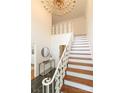 Grand foyer featuring a staircase with white railing and dark stone floors at 1928 Providence Rd, Charlotte, NC 28211