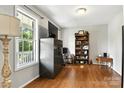 Cozy living room featuring beautiful wood floors and natural light from a large window at 2367 24Th Street Ne Ln, Hickory, NC 28601