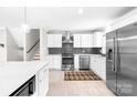 Modern kitchen features stainless steel appliances, white cabinetry, a stylish backsplash, and a spacious island at 2919 Dunaire Dr, Charlotte, NC 28205