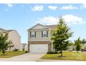 View of a home with gray siding, complemented by a green lawn and mature trees at 331 Gaines Rd, Clover, SC 29710