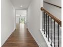 Bright hallway with hardwood floors and staircase with iron railings at 331 Gaines Rd, Clover, SC 29710