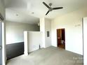 Spacious bedroom featuring a ceiling fan and carpet floors at 333 W Trade St # 505, Charlotte, NC 28202