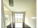 Bright living room featuring hardwood flooring and large windows at 333 W Trade St # 505, Charlotte, NC 28202