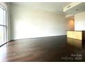 Modern living room with hardwood floors and partial kitchen view at 333 W Trade St # 505, Charlotte, NC 28202