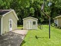 Well-kept backyard with a basketball hoop, storage shed, and partial fencing, perfect for outdoor activities at 4333 Dunwoody Dr, Charlotte, NC 28215