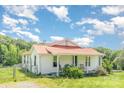 Charming one-story home with red roof, covered porch, and lush green yard at 439 Neisler Rd, Concord, NC 28025