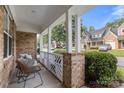 Relaxing porch area with comfortable seating and a view of the street at 4442 Coventry Row Ct, Charlotte, NC 28270