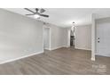 Neutral living room with hard wood flooring and modern light fixture at 4601 Coronado Dr, Charlotte, NC 28212