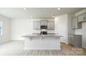 Modern kitchen featuring granite countertops, stainless steel appliances, and stylish gray cabinetry at 4685 Mammoth Rd, Hickory, NC 28602