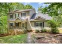 Charming two-story home with stone accents, covered front porch, and mature trees at 500 Mount Pleasant N Rd, Mount Pleasant, NC 28124