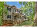 Charming two-story home with stone accents, covered front porch, and mature trees at 500 Mount Pleasant N Rd, Mount Pleasant, NC 28124