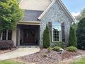 Elegant home entrance with double doors, stone accents, and professional landscaping at 5112 Mill Race Ln, Lancaster, SC 29720