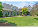 Charming stone house with lush green lawn and meticulous landscaping at 5112 Mill Race Ln, Lancaster, SC 29720