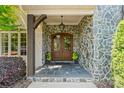 Stone porch features a decorative wood framed double door with iron accents at 5112 Mill Race Ln, Lancaster, SC 29720
