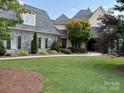 Well-maintained home featuring stone accents, lush landscaping, and a pristine green lawn at 5112 Mill Race Ln, Lancaster, SC 29720