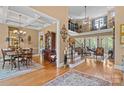 Spacious living area featuring hardwood floors, staircase, and coffered ceilings at 5112 Mill Race Ln, Lancaster, SC 29720