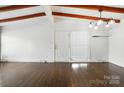 Bright living room with hardwood floors, wood beam ceiling, and ample natural light at 5229 Milford Rd, Charlotte, NC 28210