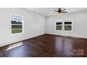 Bright, empty bedroom featuring hardwood floors and multiple windows for plenty of natural light at 556 Big Lick Rd, Stanfield, NC 28163