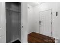 Bright entryway featuring hardwood floors, a coat closet, and a white front door at 556 Big Lick Rd, Stanfield, NC 28163