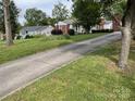 Paved driveway with home, manicured lawn and mature trees, creating an inviting curb appeal at 621 N Craige St # 25 & 27, Salisbury, NC 28144