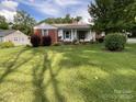 Charming single-story home with a well-maintained lawn, complemented by flowering bushes and established trees at 621 N Craige St # 25 & 27, Salisbury, NC 28144