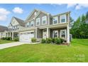 Charming two-story home with a two-car garage and a well-manicured front lawn at 812 Dogwood Creek Ln, Indian Trail, NC 28079