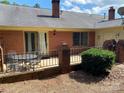 Outdoor patio with brick accents, seating, and a sliding glass door, perfect for relaxing at 8421 Coulwood Oak Ln, Charlotte, NC 28214