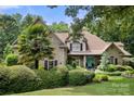Brick home featuring a welcoming front entrance and professionally landscaped yard at 849 Savile Ln, Fort Mill, SC 29715