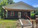 Inviting home with a covered porch and classic shutters offers a welcoming entrance and traditional charm at 94 James Sw St, Concord, NC 28025
