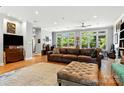 Bright living room featuring hardwood floors, large windows, and a comfortable leather sofa and ottoman at 1009 13Th Avenue Nw Pl # 19, Hickory, NC 28601