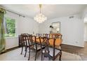 Bright dining room with an elegant chandelier, hardwood floors, and space for large table at 1040 Goshen Pl, Charlotte, NC 28211